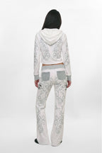 (JWL5808)Pantalones de chándal de tiro bajo Rock Revival by Jaded London con estampado gráfico en blanco